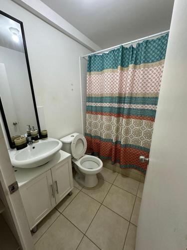 a bathroom with a sink and a toilet and a shower at Casa & Habitaciones in Mejillones