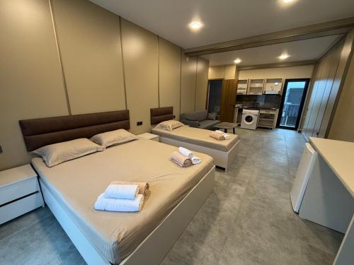 a bedroom with two beds with towels on them at Park Avenue Kobuleti in Kobuleti