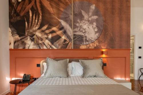 a bedroom with a bed with an orange headboard at Relais Villa Flora Berta in Matelica