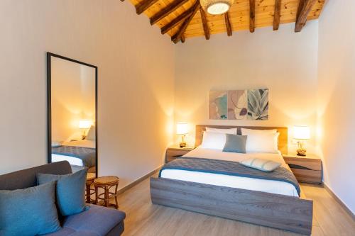 a bedroom with a bed and a couch at Pappous workplace in Skiathos