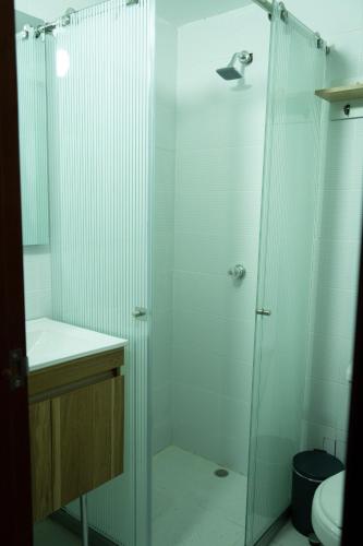 a bathroom with a shower with a sink and a toilet at La Malena, Casa Hotel in Valledupar