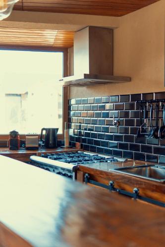 a kitchen with a stove top oven next to a window at Black Hills Caviahue in Caviahue