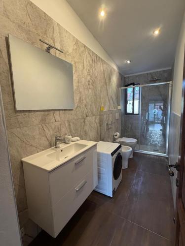 a bathroom with a sink and a toilet at Tino'S House 2punto0 in La Spezia