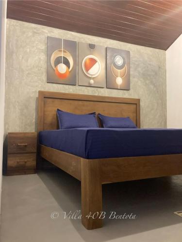 a bedroom with a bed with blue sheets and speakers at Villa 40B Bentota in Bentota