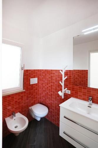 a bathroom with a white toilet and a sink at A due passi da in Corato