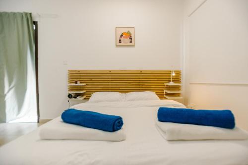 a bedroom with two beds with blue pillows on them at Villa Kokona Private Pool Sea View in Sophtadhes