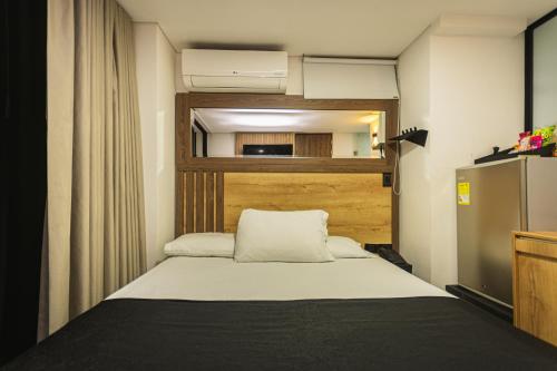 a small bedroom with a bed with a wooden headboard at HOTEL MONTANA in Bello