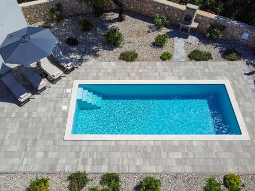 an overhead view of a swimming pool with an umbrella at Villa Dream by Interhome in Dobrinj