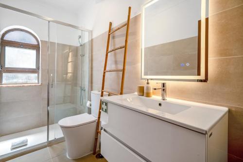a bathroom with a sink and a toilet and a shower at BeGuest Ferragudo Sunny Apartment in Ferragudo