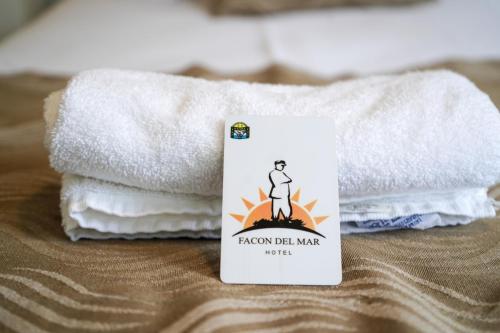 a packet of towels sitting next to a stack of towels at Facón Del Mar Hotel in Mar del Plata