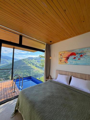 a bedroom with a bed and a window with a view at Alaçam Tatil Evleri in Trabzon