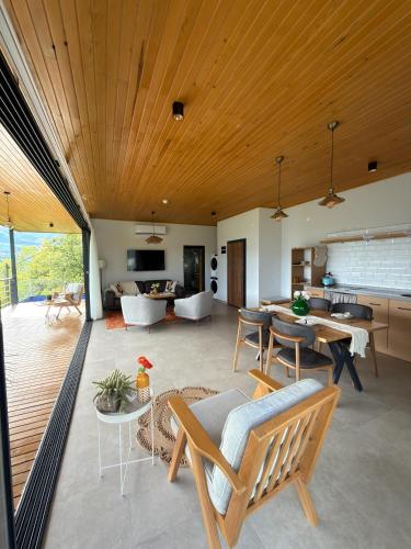 an open living room with a wooden ceiling at Alaçam Tatil Evleri in Trabzon