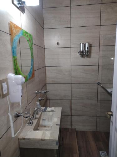 a bathroom with a sink and a mirror at Casa de Adobe Doña Tinogasta in Tinogasta