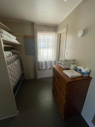a room with a bed and a dresser with towels at Admiral's Cove Resort in Lemoyne