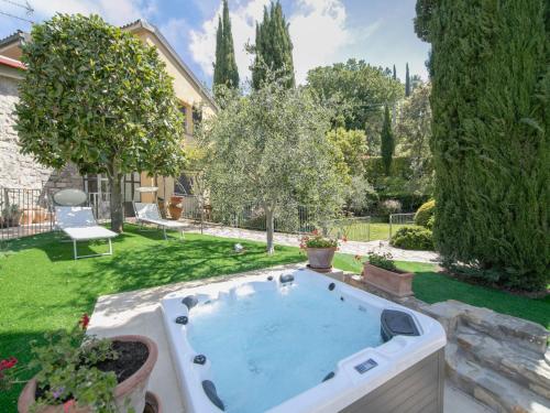 a hot tub in the backyard of a house at Apartment Villa Elisa by Interhome in Castellina in Chianti