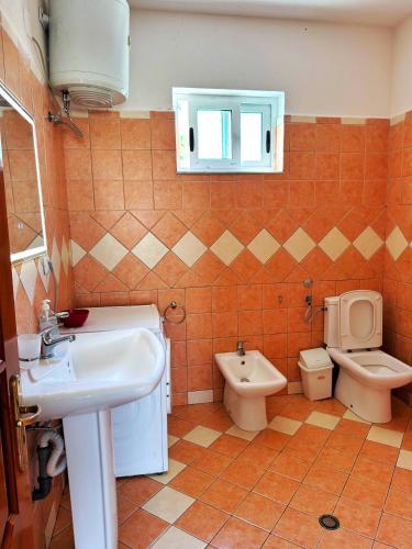 a bathroom with a sink and a toilet at Olive GREEN house in Durrës