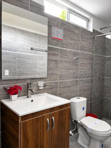 a bathroom with a sink and a toilet at PH BOUTIQUE HOTEL Girardot in Girardot