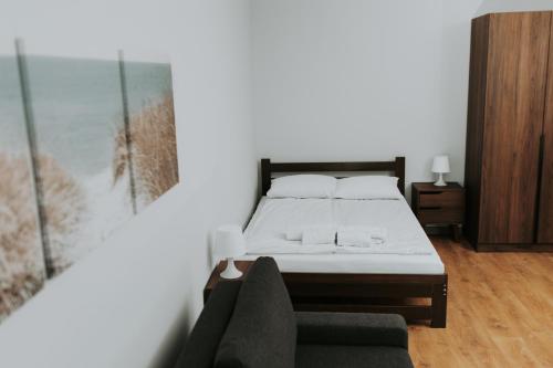 a bedroom with a bed and a couch at Złota Brama - Old Town Apartament 2 in Gdańsk