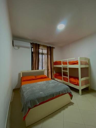 a bedroom with two bunk beds and a window at Hotel Ylberi in Golem