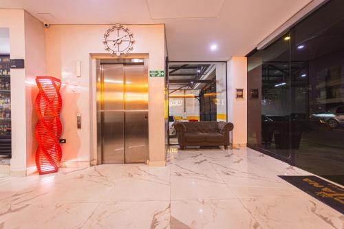 a lobby with a elevator and a glass door at HOTEL MONTANA in Bello
