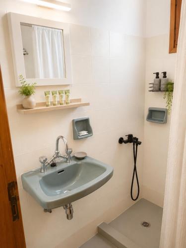a bathroom with a sink and a mirror at FILOXENIA by Evita's Resort in Poros