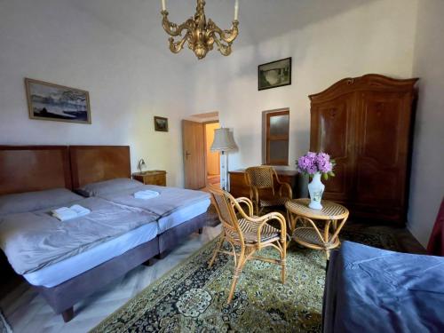 a bedroom with a bed and a table and chairs at Zámeček Rozkoš in Střížovice