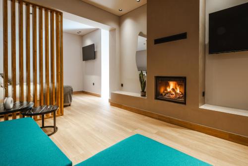 a living room with a fireplace and a couch at Grava Aurum - City Suites in Igoumenitsa