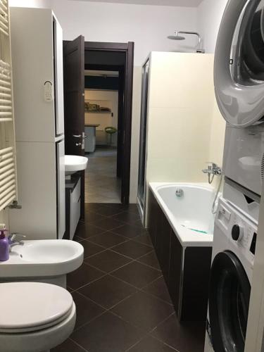 a bathroom with a toilet and a sink and a washing machine at My house in Turin