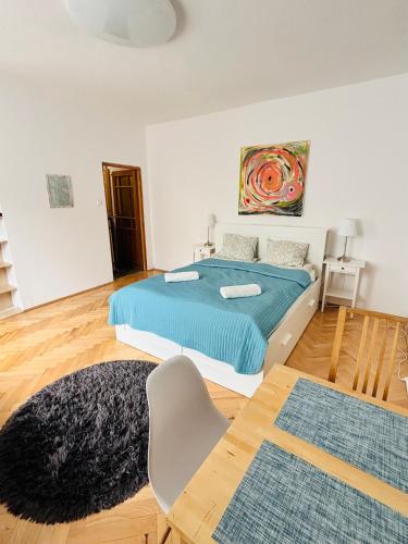 a bedroom with a bed and a chair in it at Gdynia Abrahama 48 in Gdynia