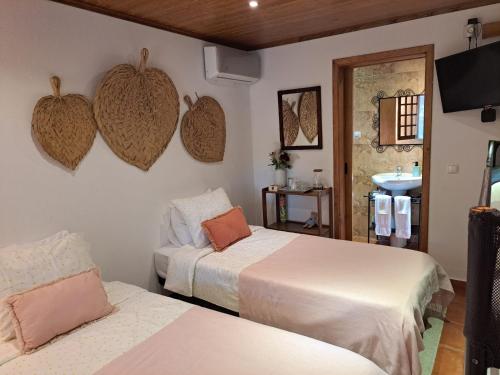 a room with two beds and a sink in a room at Quinta do Vale Encantado "the Valley" - Santarém - Portugal in Calhariz