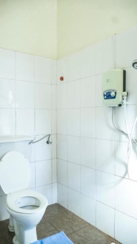 a bathroom with a white toilet in a room at SuPas Bistro in Kisoro