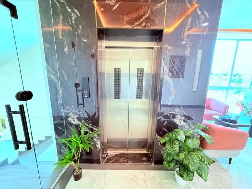 a elevator in a room with plants in front of it at Hotel Purple Lotus Suites in Chauk