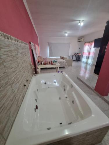 a large white bath tub in a living room at Casa AONIKENK in Villa Dolores