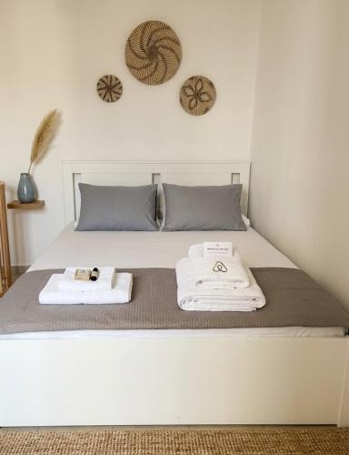 a bed with two towels sitting on top of it at Harmony Serifos in Livadi