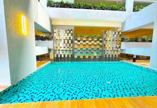 a large swimming pool in a building at Blue aura in Kuala Lumpur