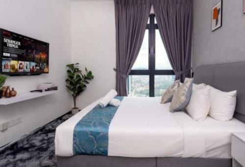 a bedroom with a large bed with a window at Blue aura in Kuala Lumpur