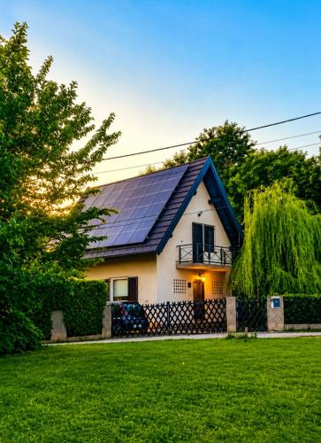 a house with solar panels on the roof at GreenHouse pool & spa in Otruševec