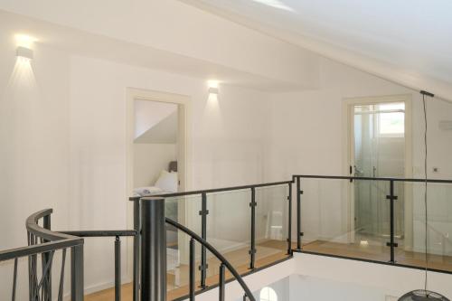 a white room with a staircase and a mirror at Apartmani Zora in Primošten
