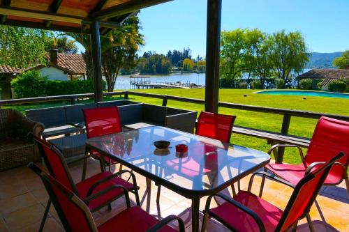 a table and chairs on a patio with a view of a lake at Lake Rapel, beautiful lake view in Las Cabras
