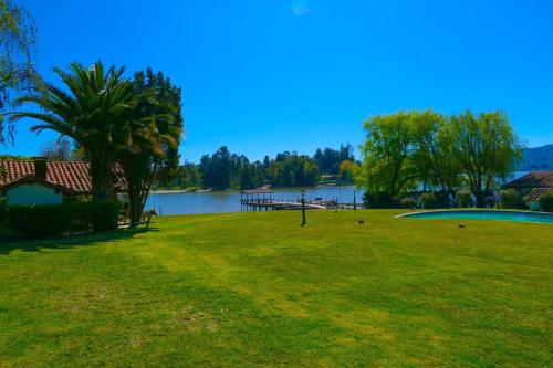 a park with a lake in the background at Lake Rapel, beautiful lake view in Las Cabras