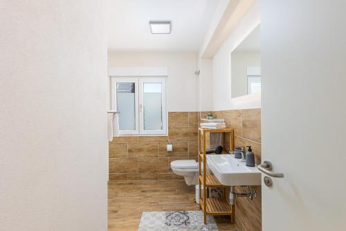 a bathroom with a sink and a toilet at Ferienhaus Primavera in Mörsdorf