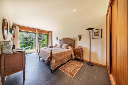 a bedroom with a bed and a window at Casa do Rego - by Proguest in Valdosende