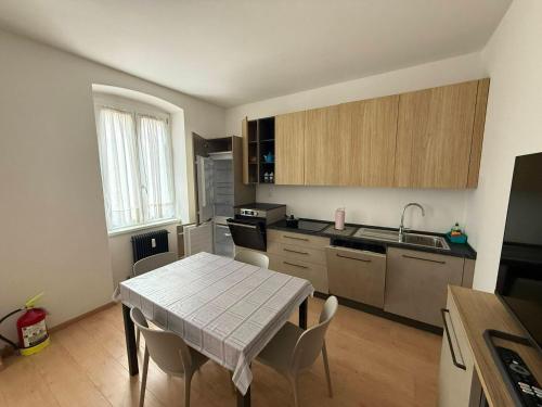 a kitchen with a table and a table and chairs at Casa Lina in Cavalese