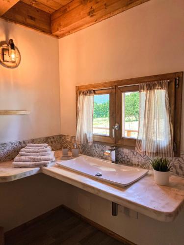 a bathroom with a sink and a window at Guarda Che Luna in Sasso di Castalda