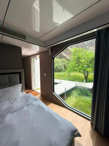 a bedroom with a bed and a large window at ZEVS-Holiday Complex in Deu