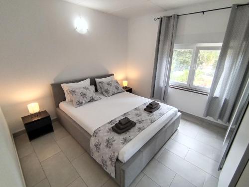 a bedroom with a bed and a window at Holiday home I.D.A. in Banjole