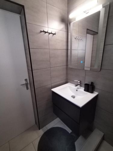 a bathroom with a sink and a mirror at Holiday home I.D.A. in Banjole