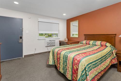 a hotel room with a bed and a window at Village Lodge in Bristol