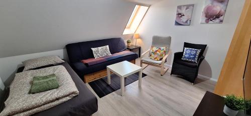 a living room with a couch and a chair at Cottage in the middle of nowhere 2 in Ölfus
