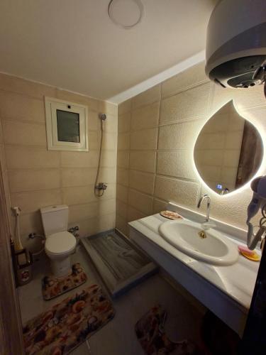 a bathroom with a sink and a toilet at Hurghada HuB in Hurghada